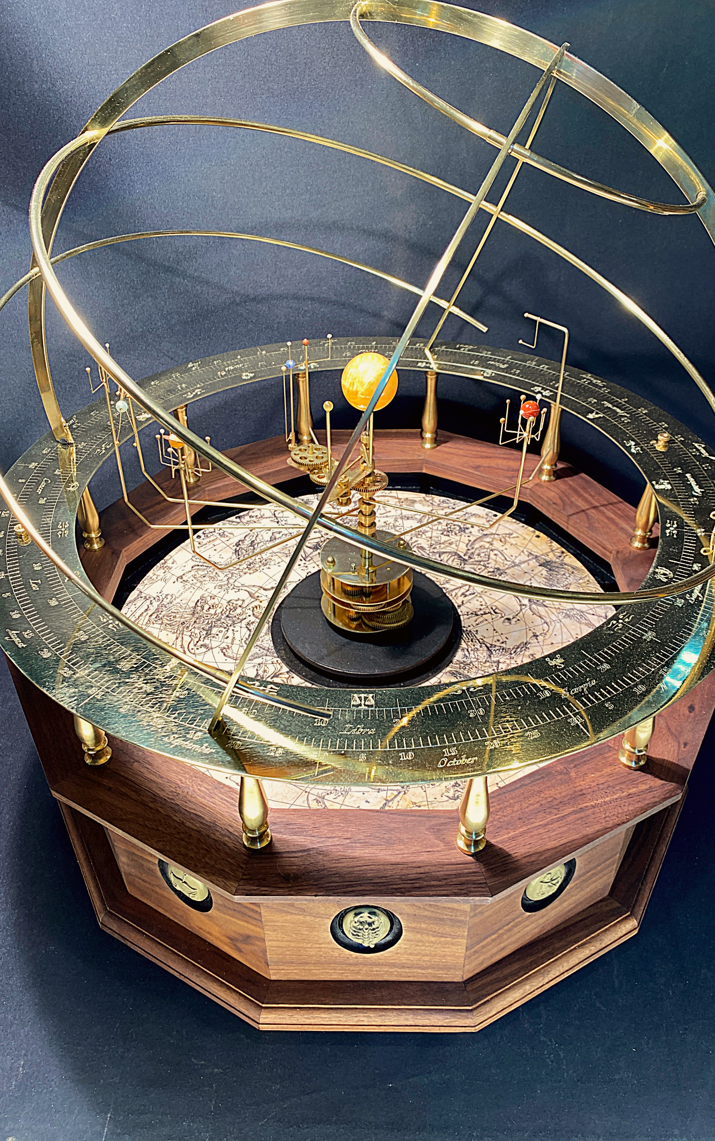 A museum quality Orrery, made of brass and semi-precious stones, displaying the relative positions and movements of planets in the solar system.