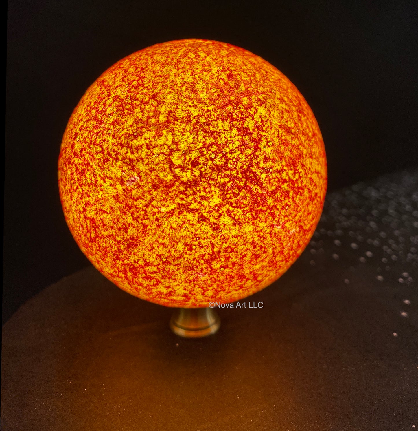 Depicts the Sun in brilliant orange red hydrogen alpha