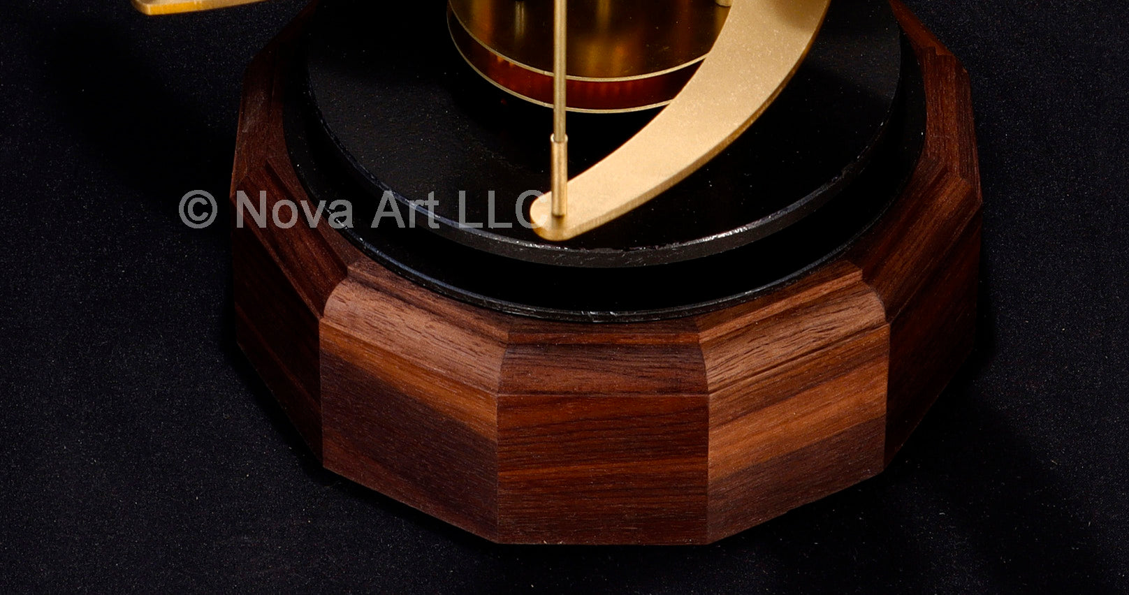 The solid walnut hardwood base of the Trappist-1 orrery solar system model.