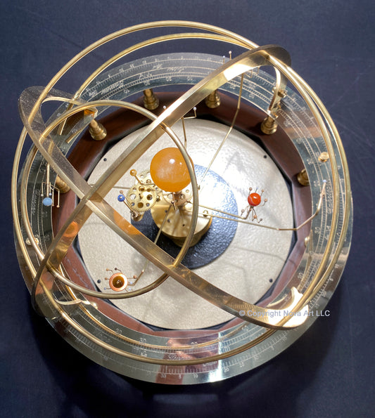 A Baby Grand Armillary Orrery made by Science Art with brass gears and semi-precious stone planets arranged within a wooden frame, displaying the relative positions of planets and moons in our solar system.