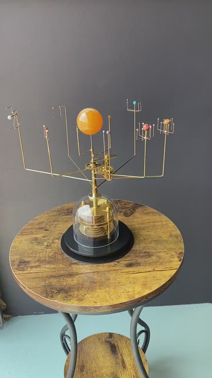 Views depicting the movement of the orrery, showing the planets revolving in correct relative orbital speeds.