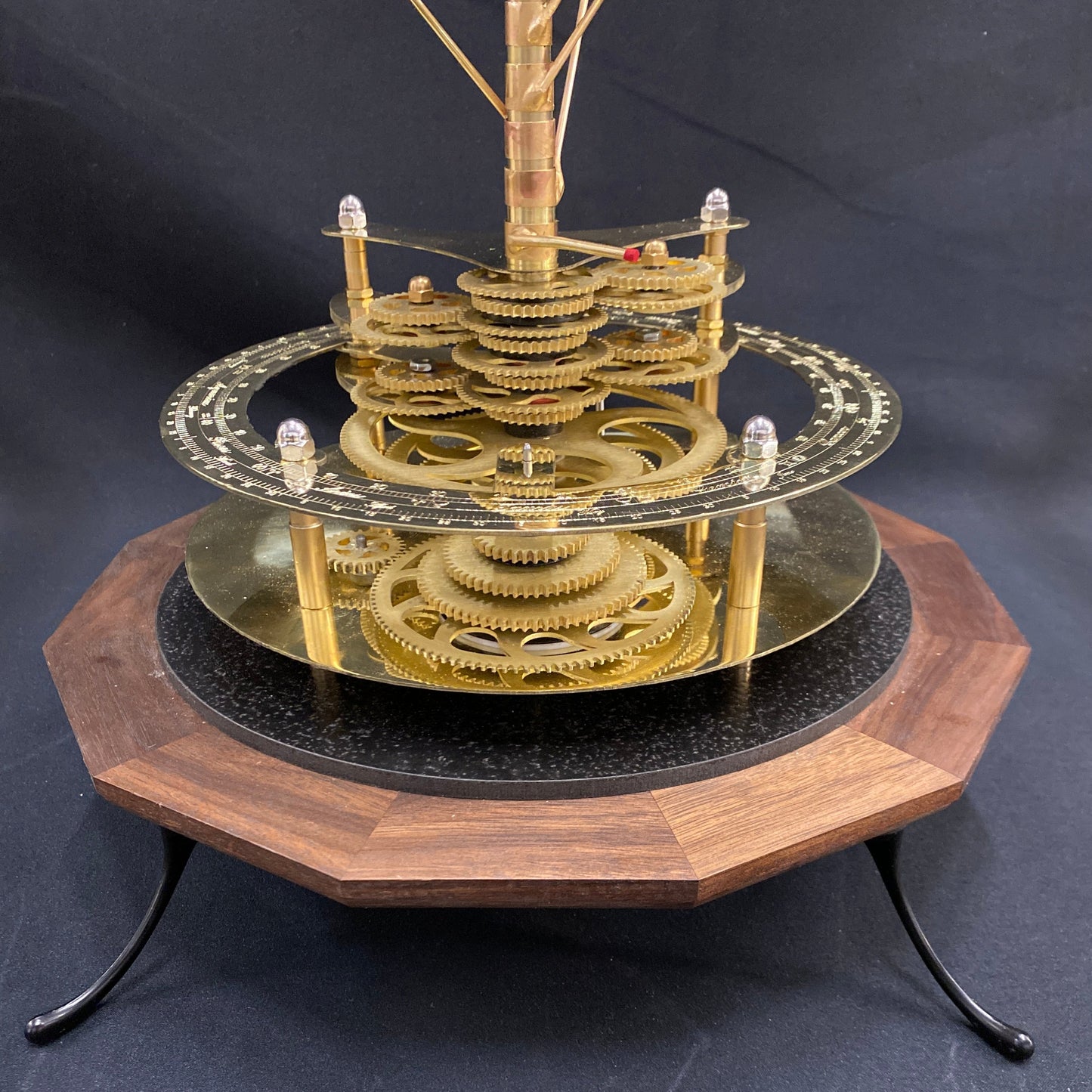 Close up of Renaissance Orrery showing solid brass gearworks and walnut base