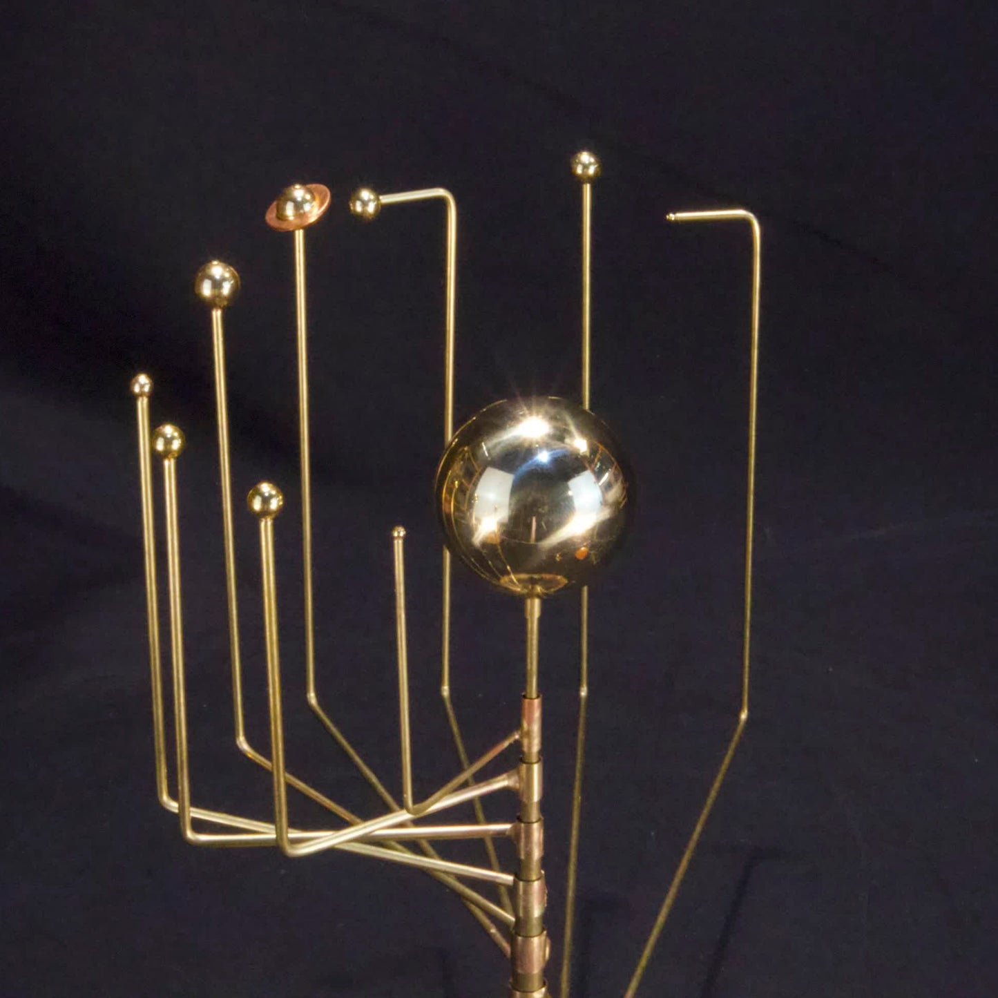 Close up of orrery with brass Sun and planets