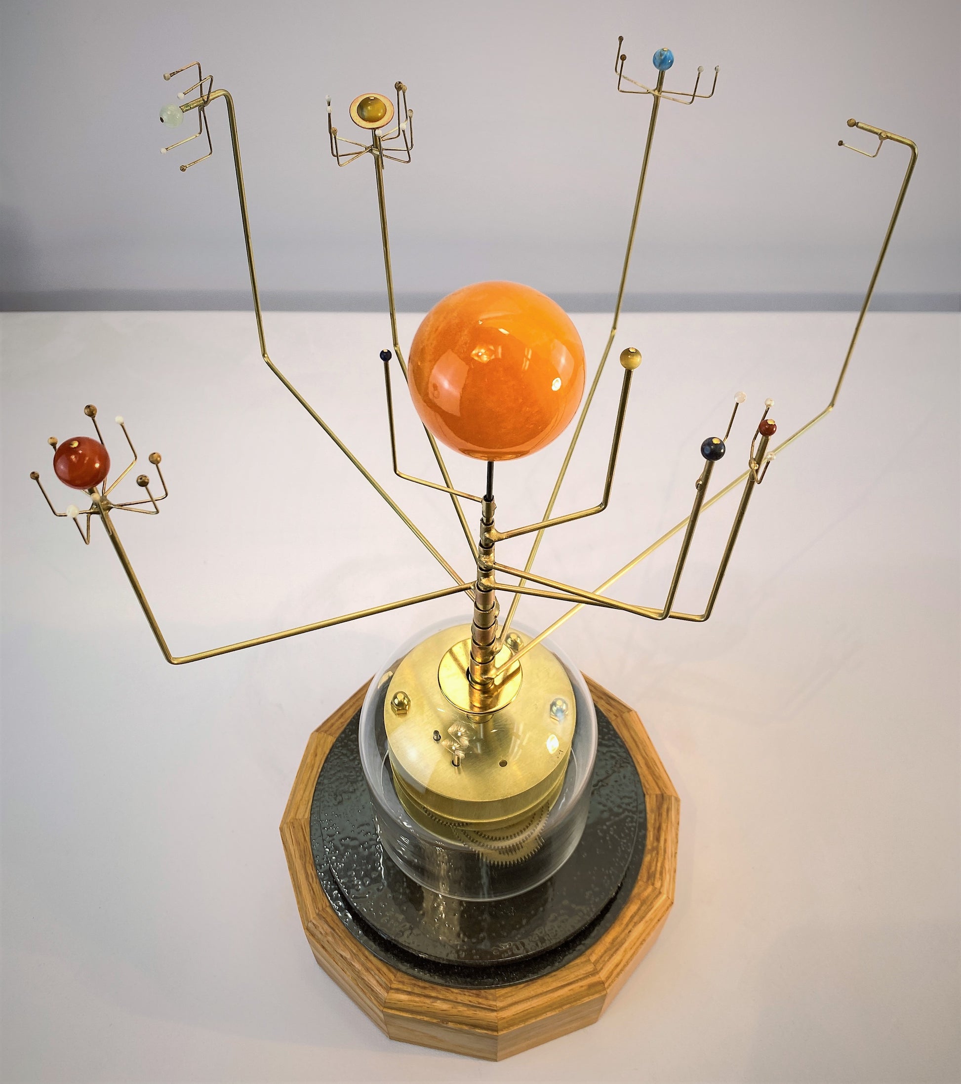 Video of Wanderers Orrery in semi-precious stone with a walnut base. Orrery depicts the correct relative orbital speeds of the nine planets in solar system. 