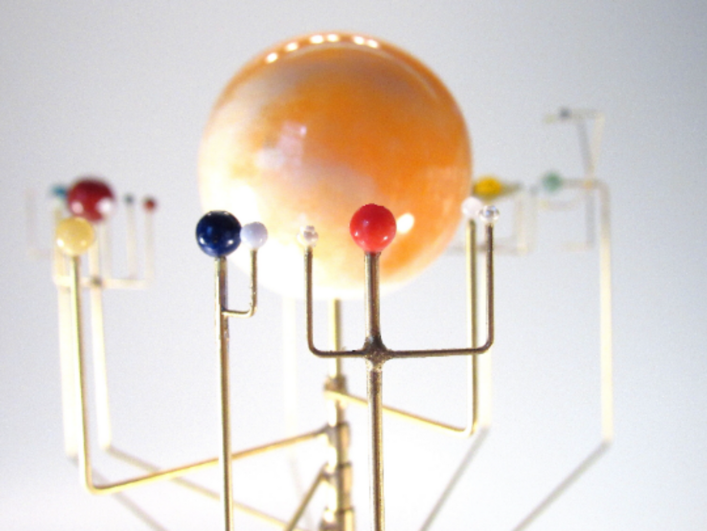 close up of orrery with semi-precious stones Earth Mars