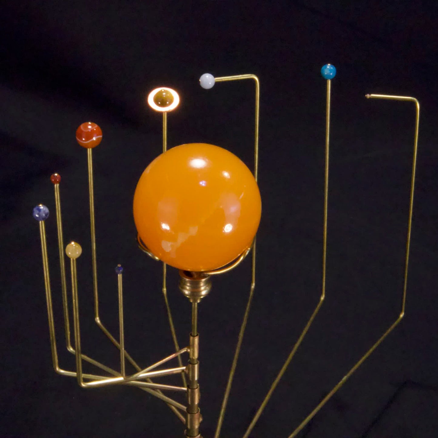 close up of orrery with semi-precious stone planets