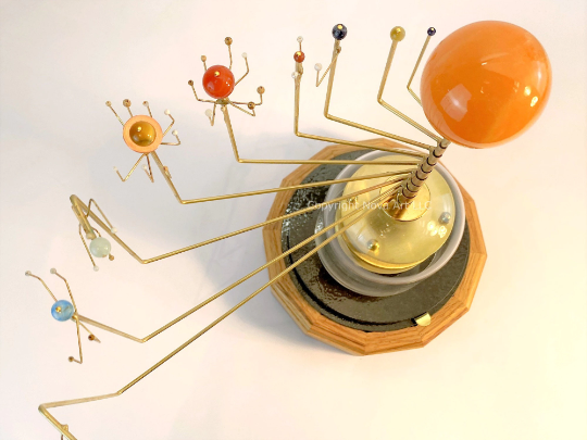 Photography of Wanderers Orrery with semi-precious stone planet set